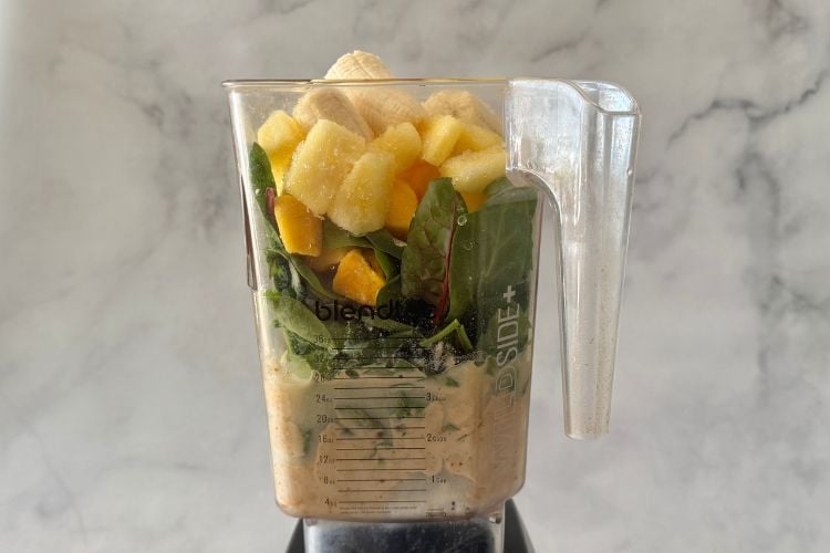 Green smoothie ingredients in blender