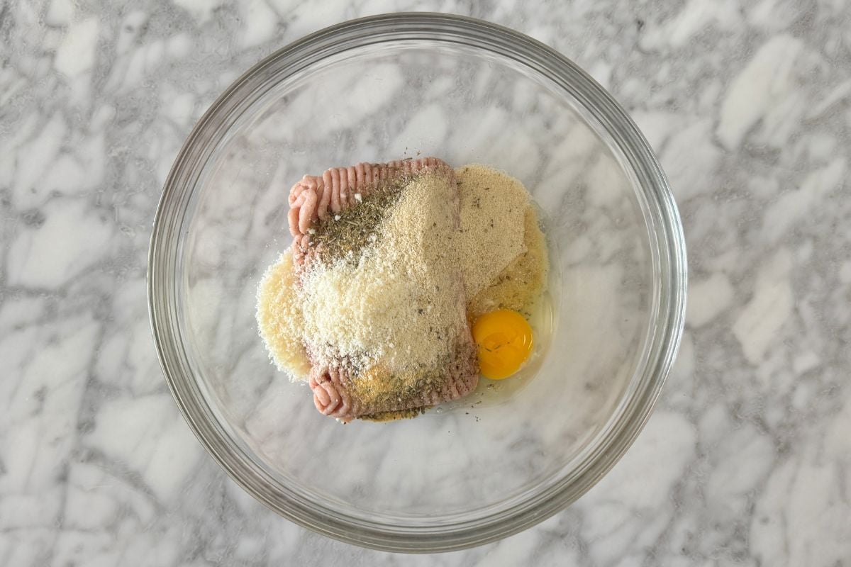 Ground chicken in bowl for chicken parmesan meatballs
