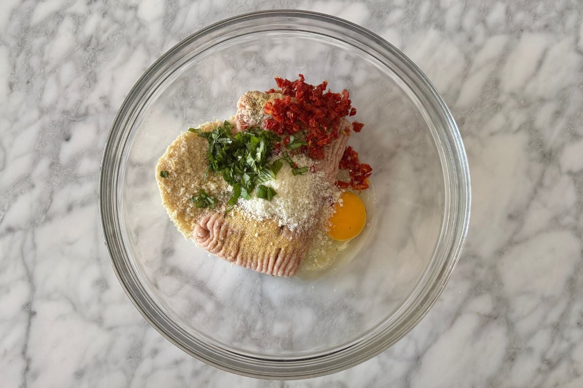 Ground chicken in a bowl with sun-dried tomatoes