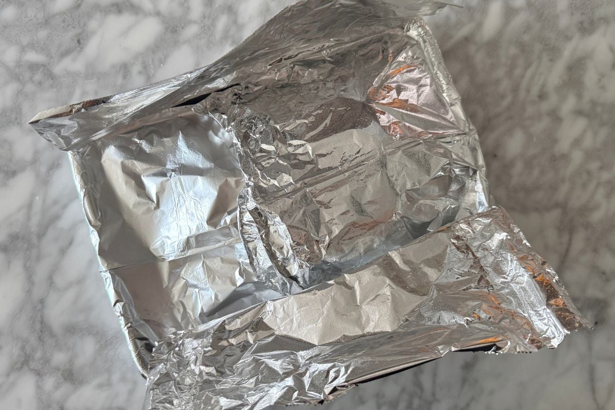 Cooked ham covered with foil