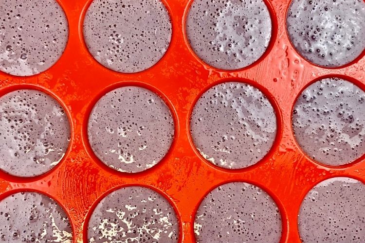 Healthy blueberry cheesecake batter in muffin tin