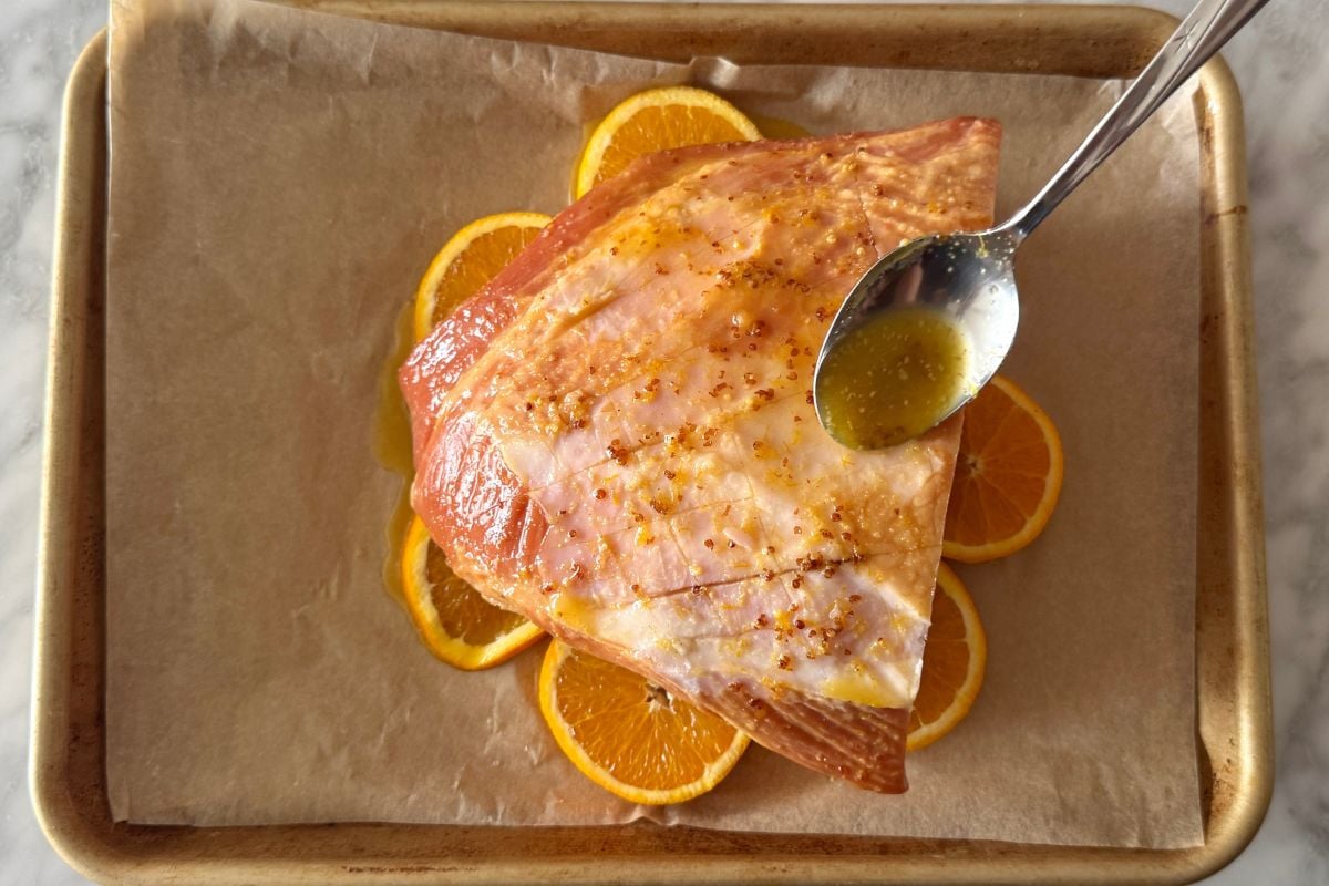 Honey and orange glaze on cooked carver ham