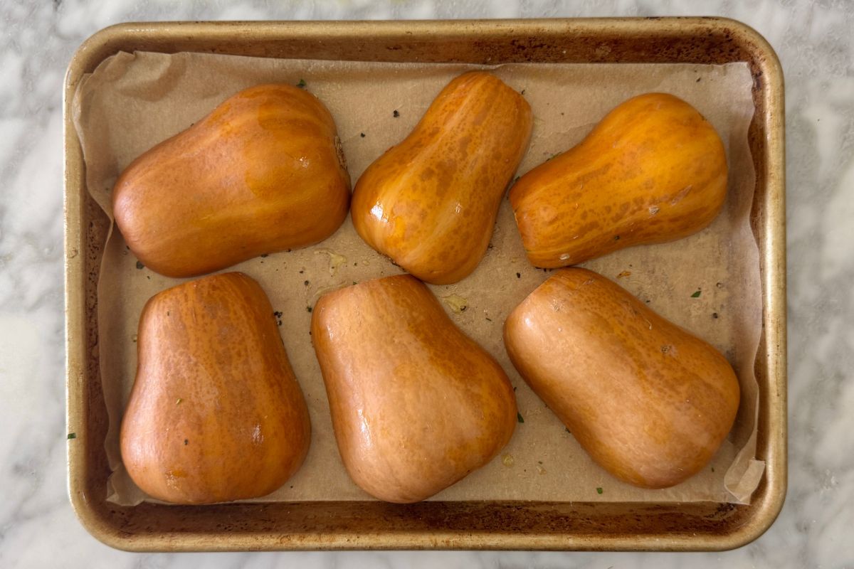 Honeynut squash cut side down on baking sheet