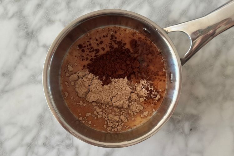 Hot chocolate with protein powder in saucepan