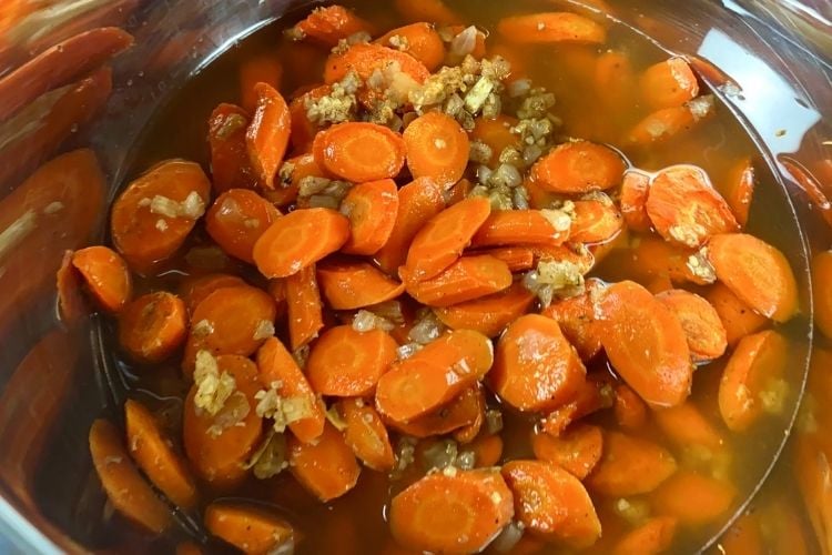 Ingredients in a saucepan for the roasted carrot ginger soup