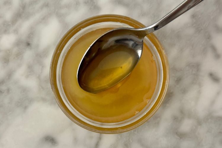 Lemon juice and honey mixed together in bowl