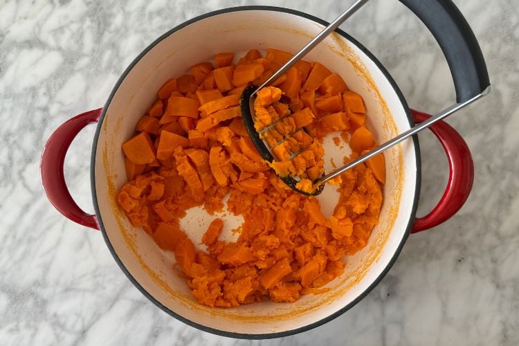 Mashed sweet potatoes in a large pot