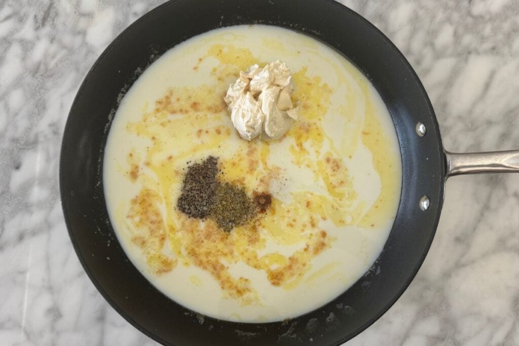 Milk and cream cheese in a pan