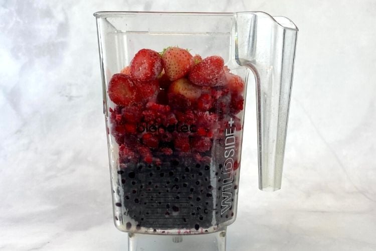 Mixed berry smoothie bowl in blender