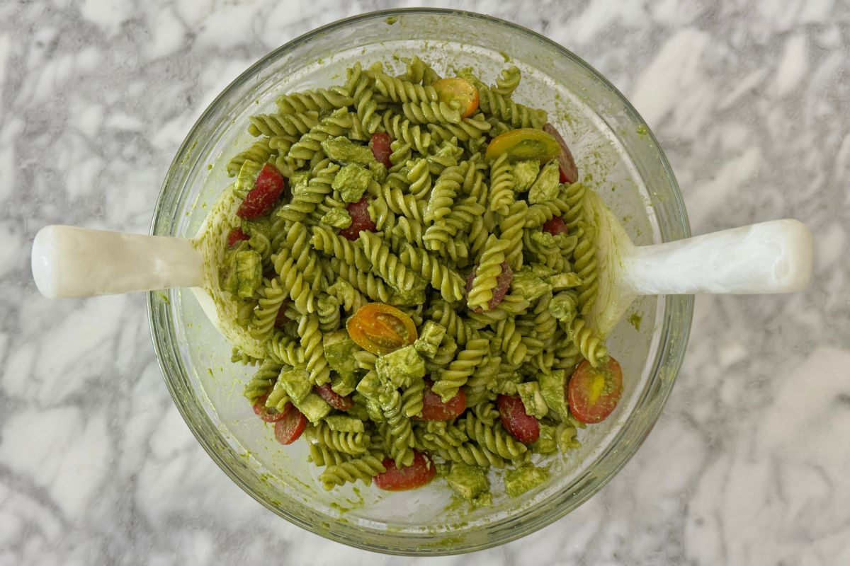 Mixed chicken pesto pasta salad in bowl