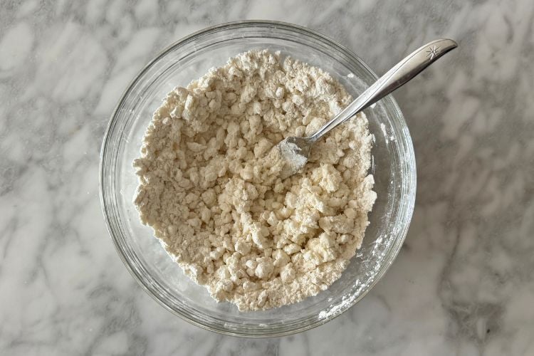 Mixed cottage cheese and flour in bowl