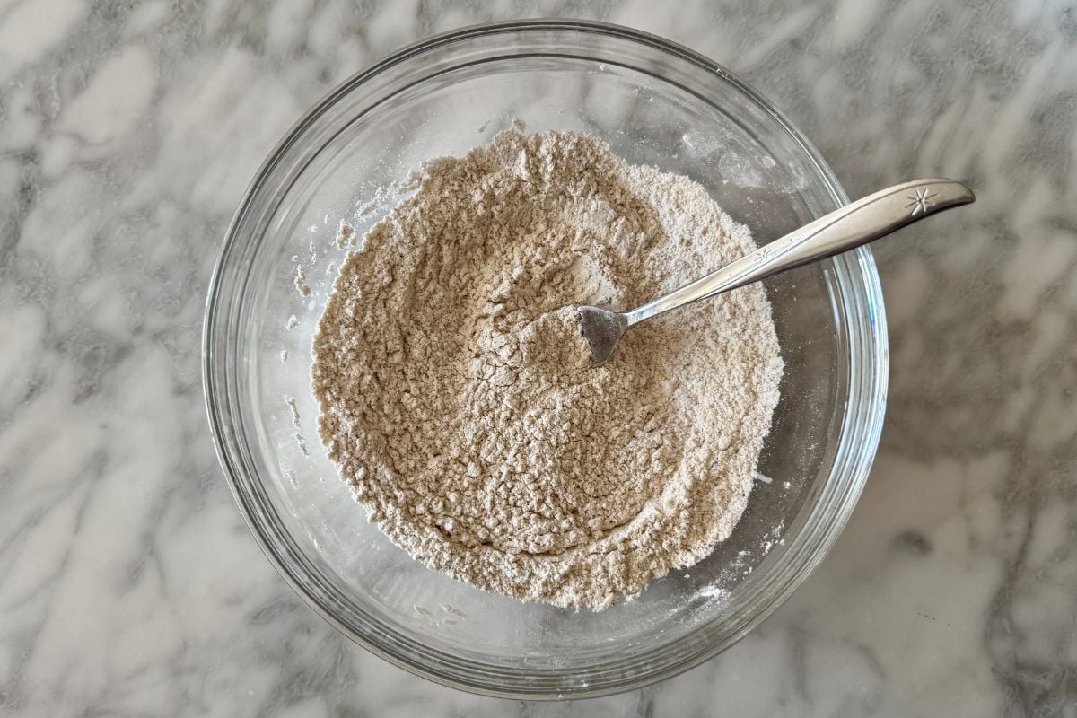 Mixed dry ingredients for cinnamon crunch bagels in bowl