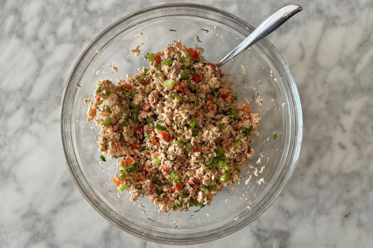 Mixed ingredients for salmon salad in bowl