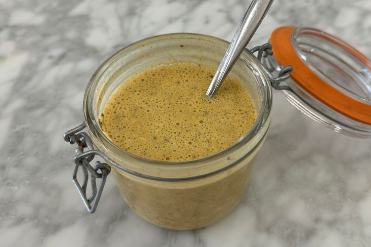 Mixed pumpkin protein overnight oats in a jar.