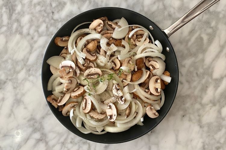 Mushrooms and onions in a pan