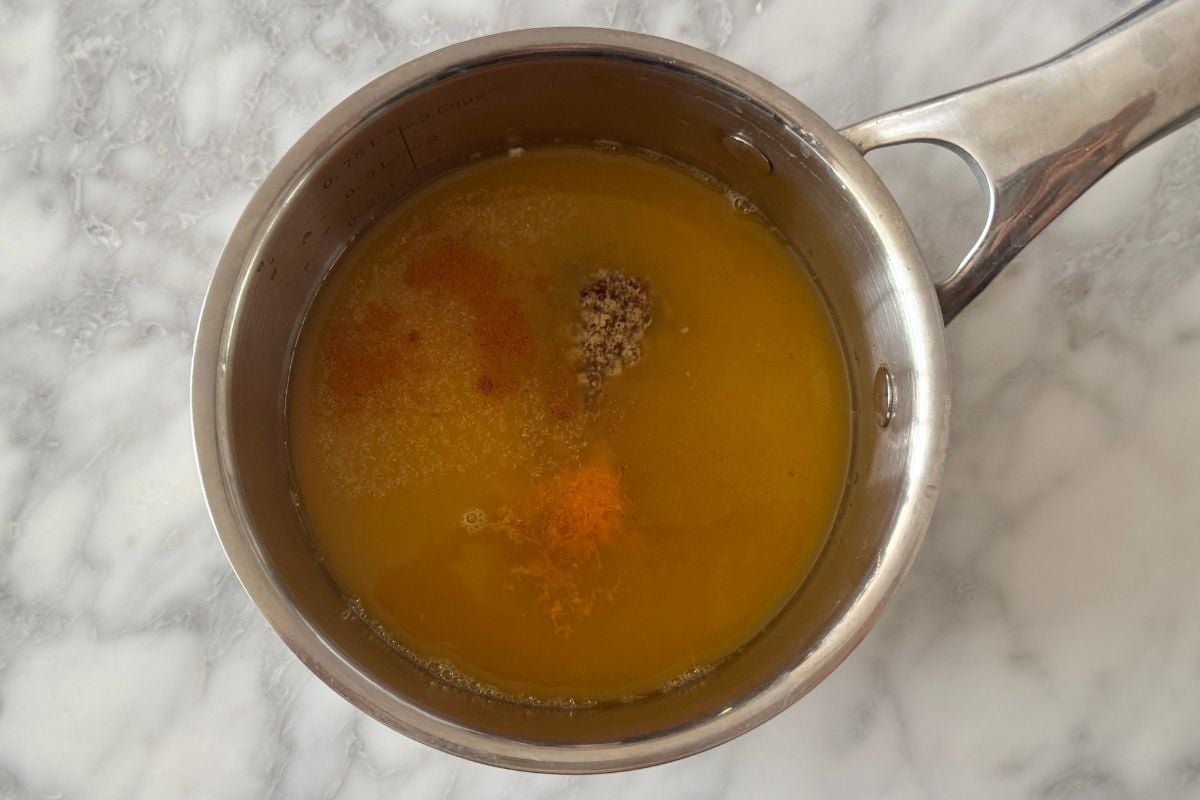 Orange juice in saucepan with seasonings