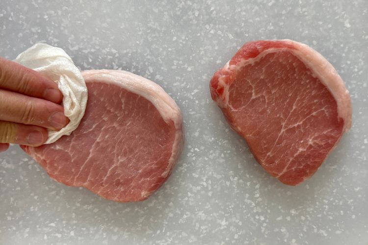 Pat dry the pork chops with a paper towel