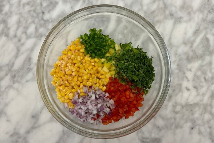 Pineapple corn salsa ingredients in bowl