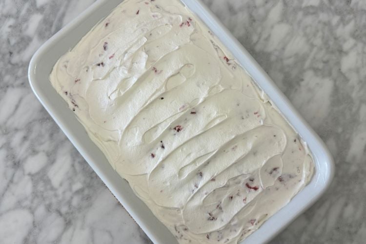Poke cake topped with whipped cream
