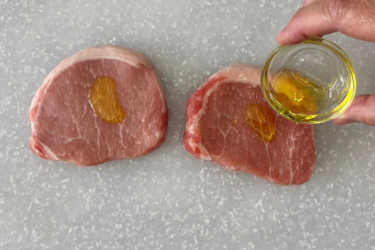 Pork chops rubbed with olive oil