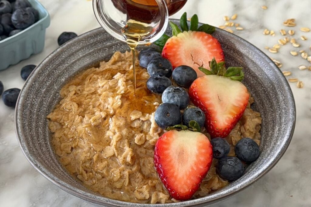 Protein oatmeal served in a bowl with fruit
