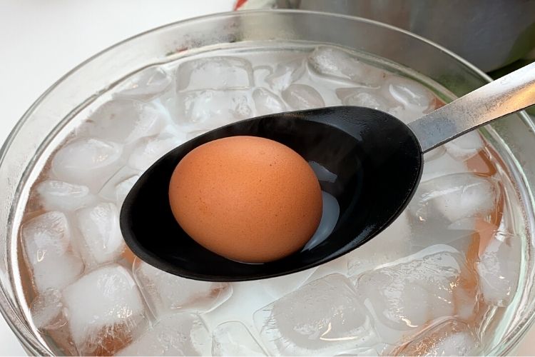 Putting egg into ice bath