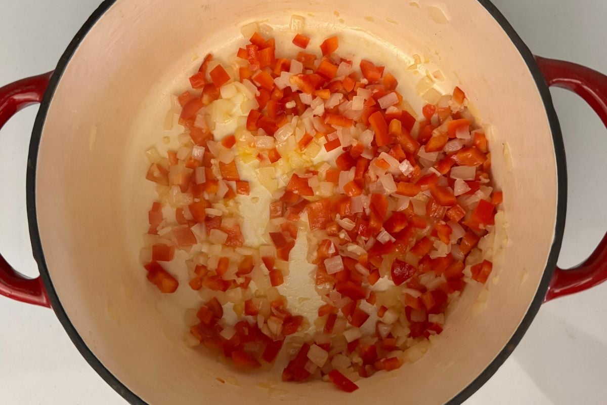 Red bell pepper onion and garlic cooked in Dutch oven