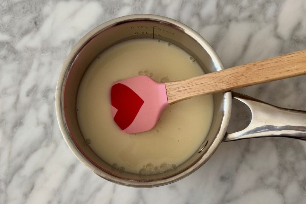 Rolled oats in a saucepan with milk for oatmeal