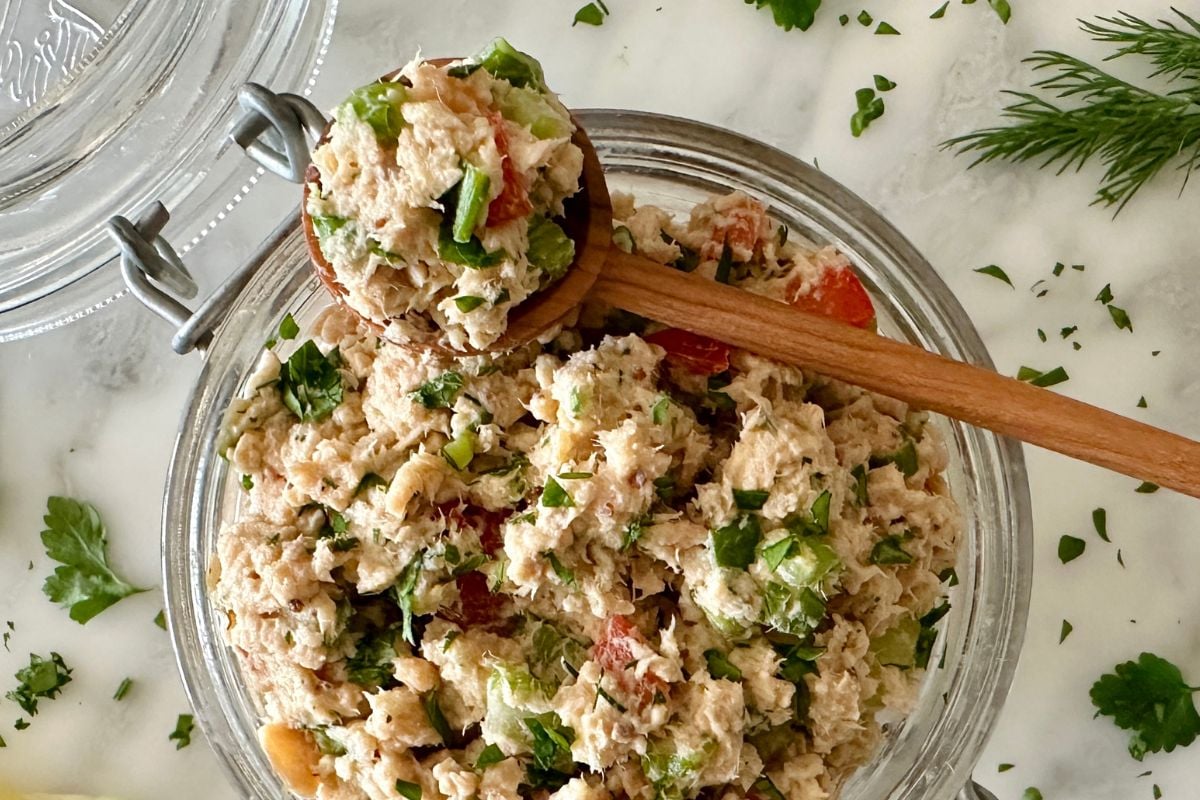 Salmon salad in a bowl with spoon