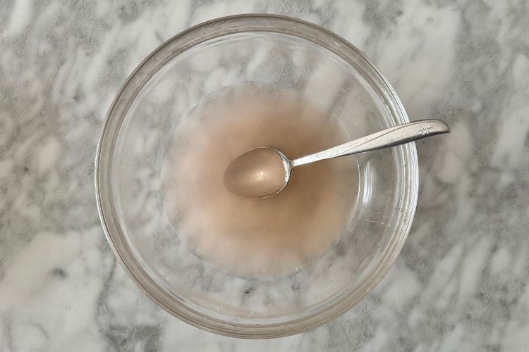 Salt dissolved in warm water in a bowl
