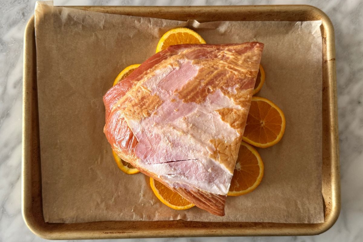 Scored carver ham on orange slices