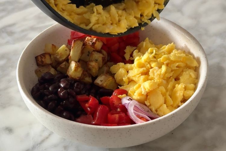 Scrambled eggs in bowl with other ingredients