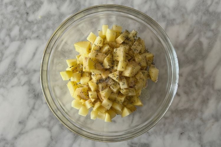 Seasoned diced potatoes in bowl