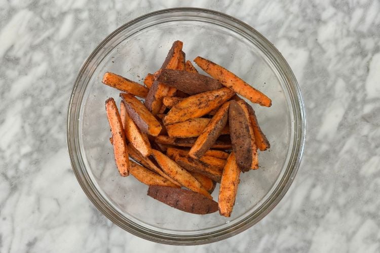 Seasoned sweet potato wedges in bowl