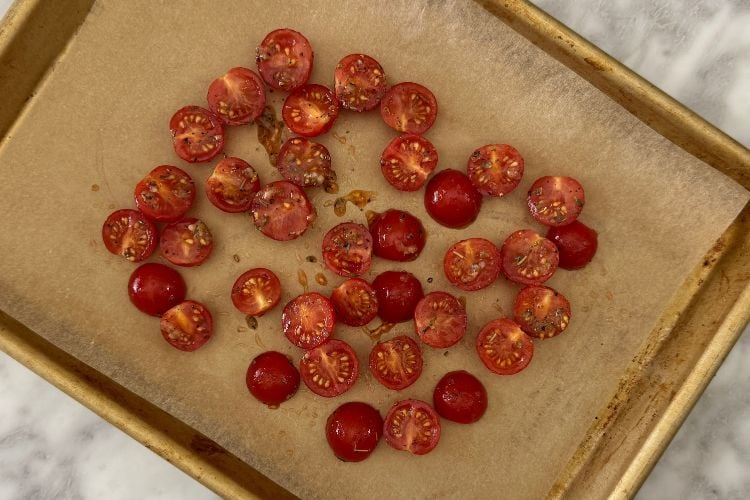 Seasoned tomatoes on a sheet pan