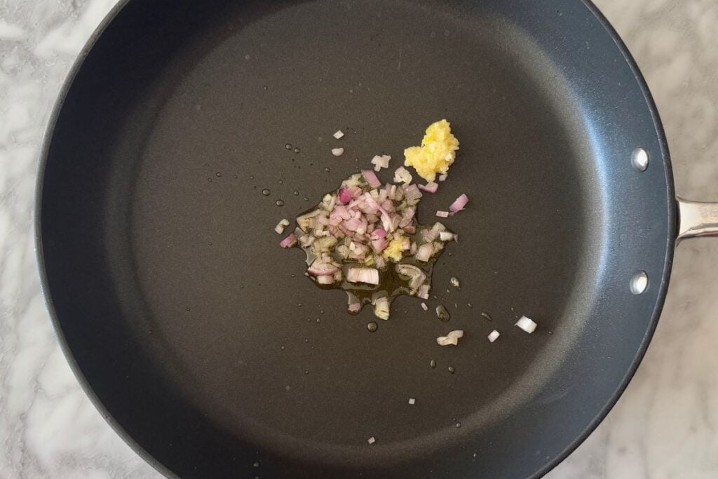 Chopped shallots and crushed garlic in a skillet
