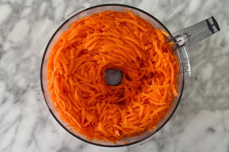 Shredded carrots in a food processor