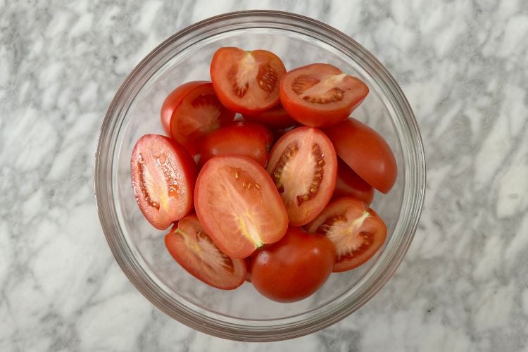 Sliced Roma tomatoes in bowl