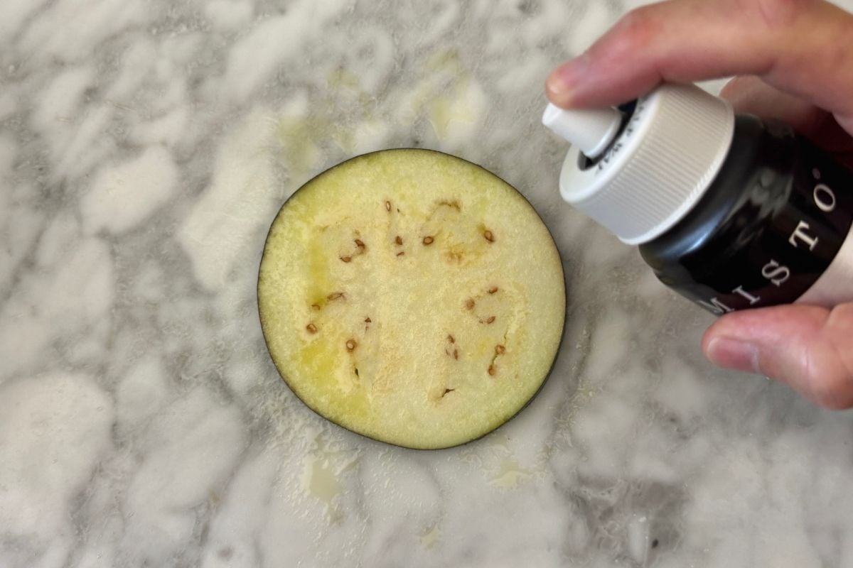 Sliced eggplant sprayed with olive oil