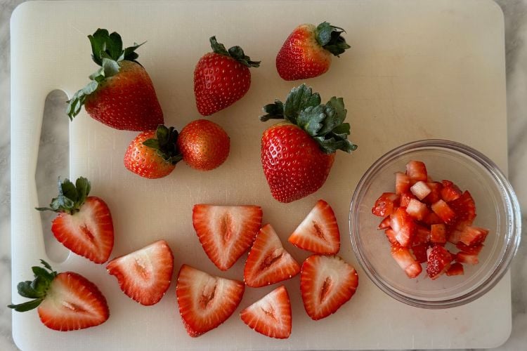 Sliced fresh strawberries on cutting board