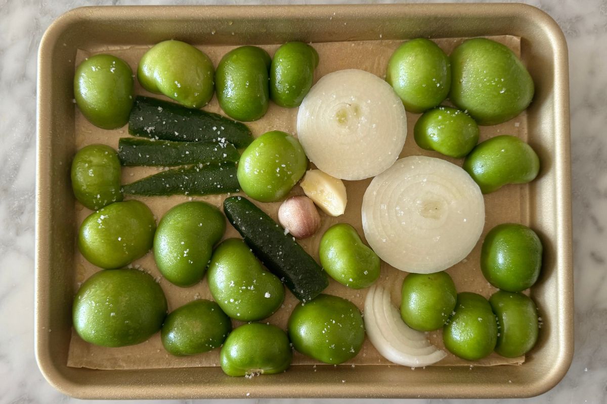 Sliced tomatillos on a sheet pan