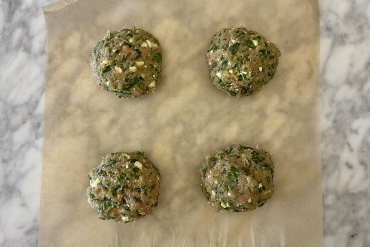 Spinach and feta turkey burgers mixture in bowl