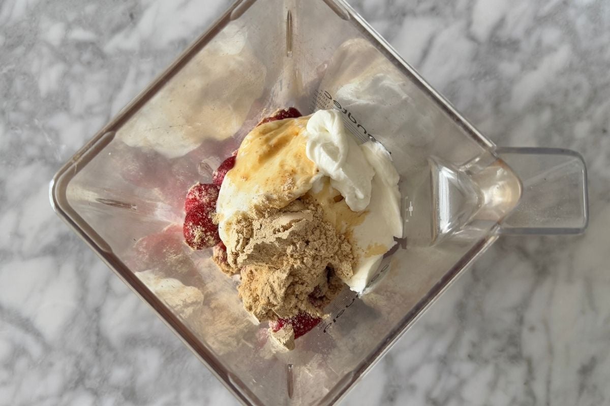 Strawberry frozen yogurt ingredients in blender