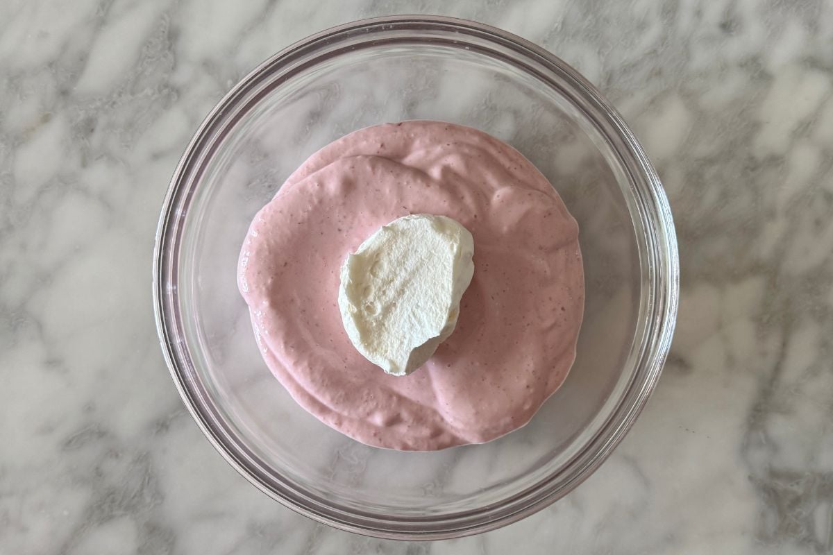Strawberry mousse in bowl with whipped topping