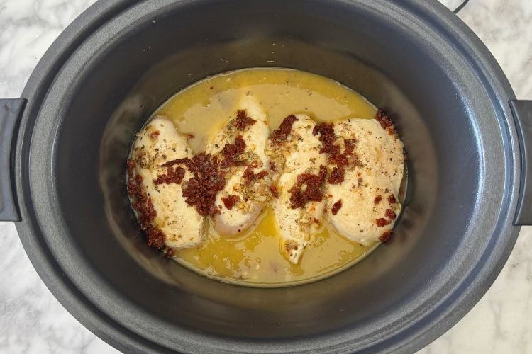Sun dried tomatoes and chicken broth in slow cooker