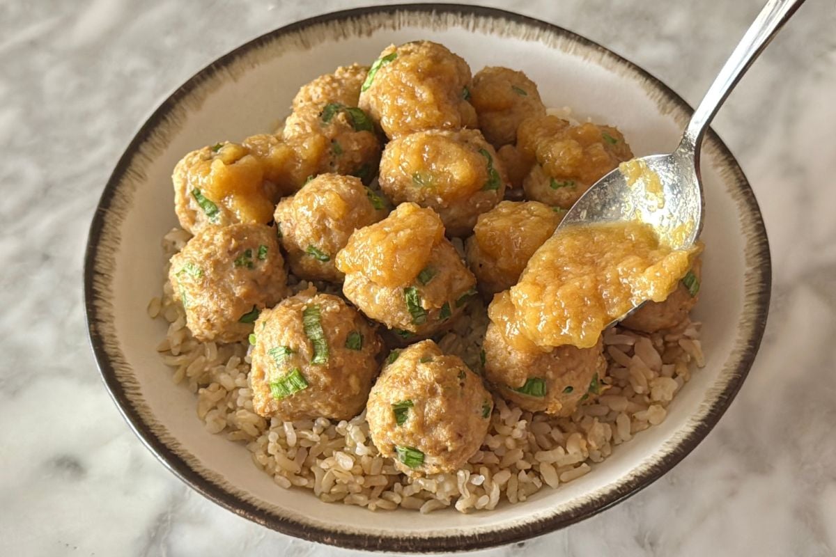 Teriyaki meatballs with sauce served over brown rice in a bowl
