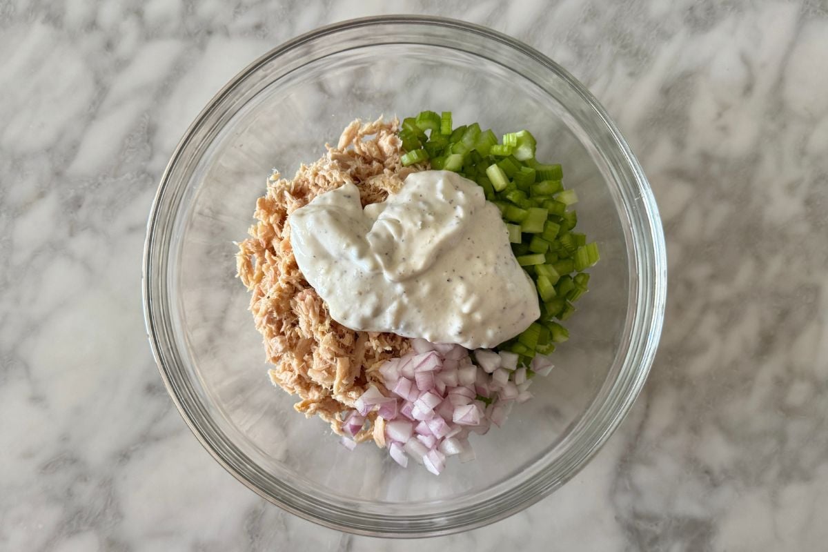 Tuna mixture and sauce in bowl for tuna salad