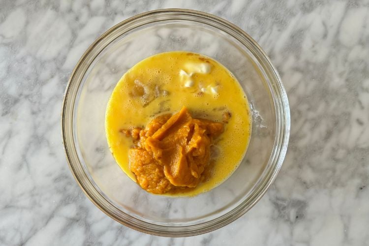 Wet ingredients in bowl for pumpkin oat muffins