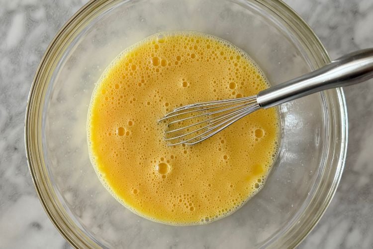 Whisked eggs in a large bowl