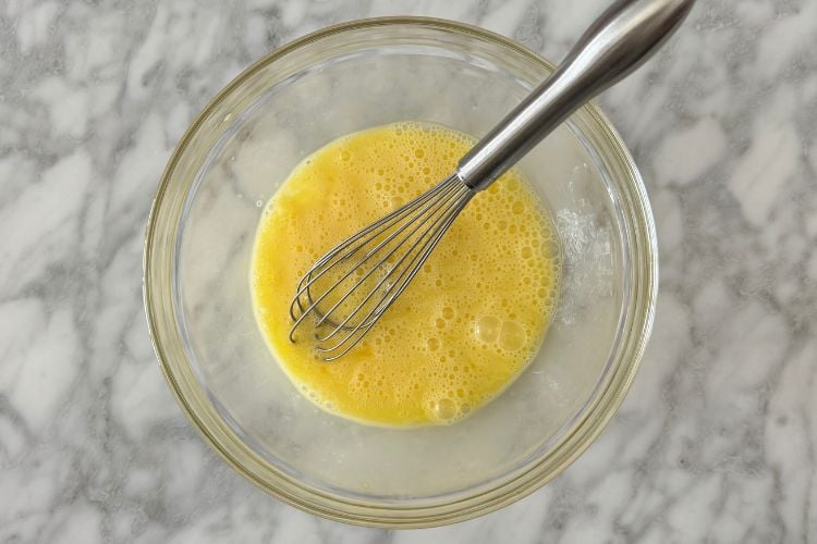 Whisked eggs in a large bowl